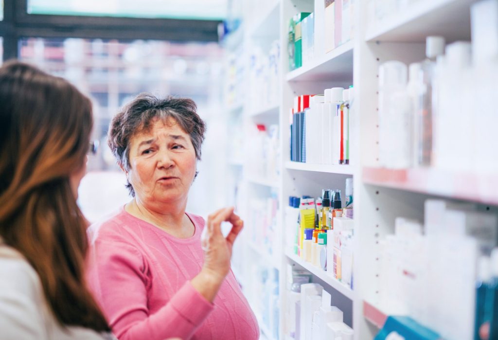 Customer choosing a vitamin product from the shelf
