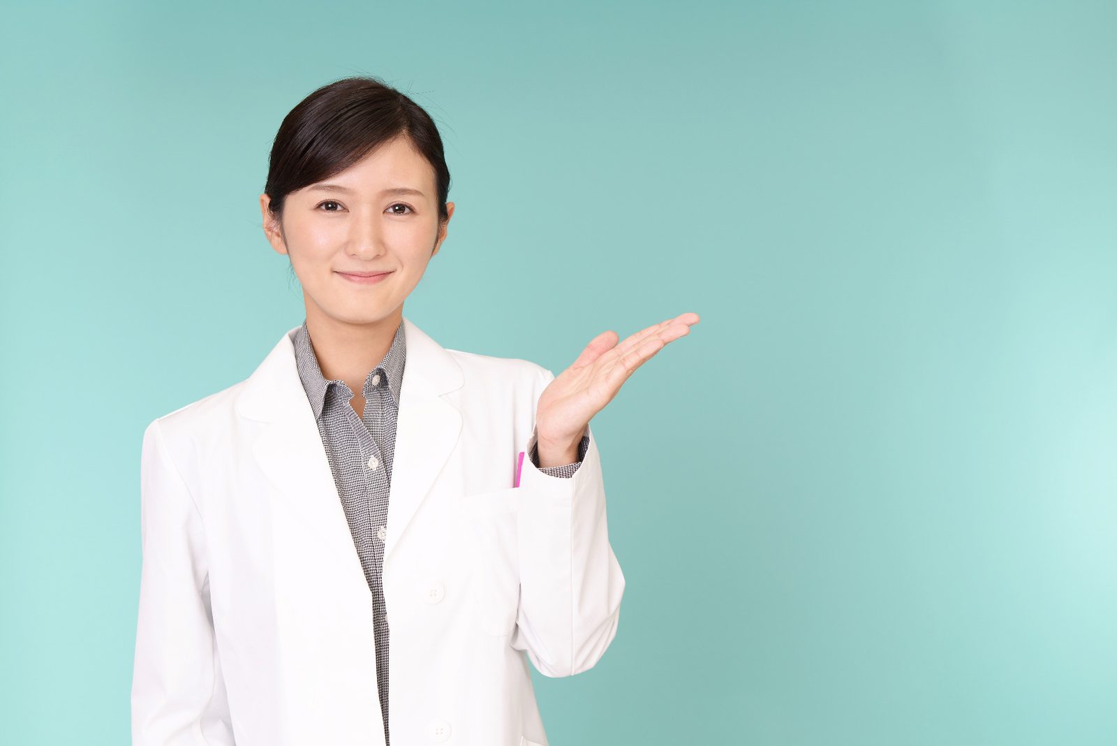 A pharmacist in a white coat at the pharmacy counter